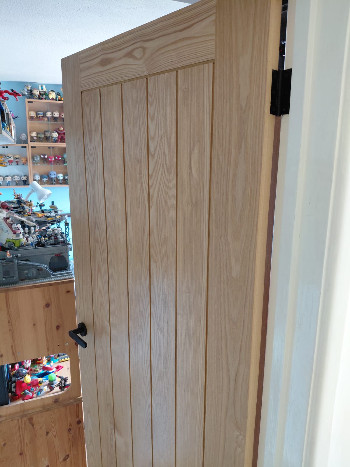 Oak internal door hung in a white frame