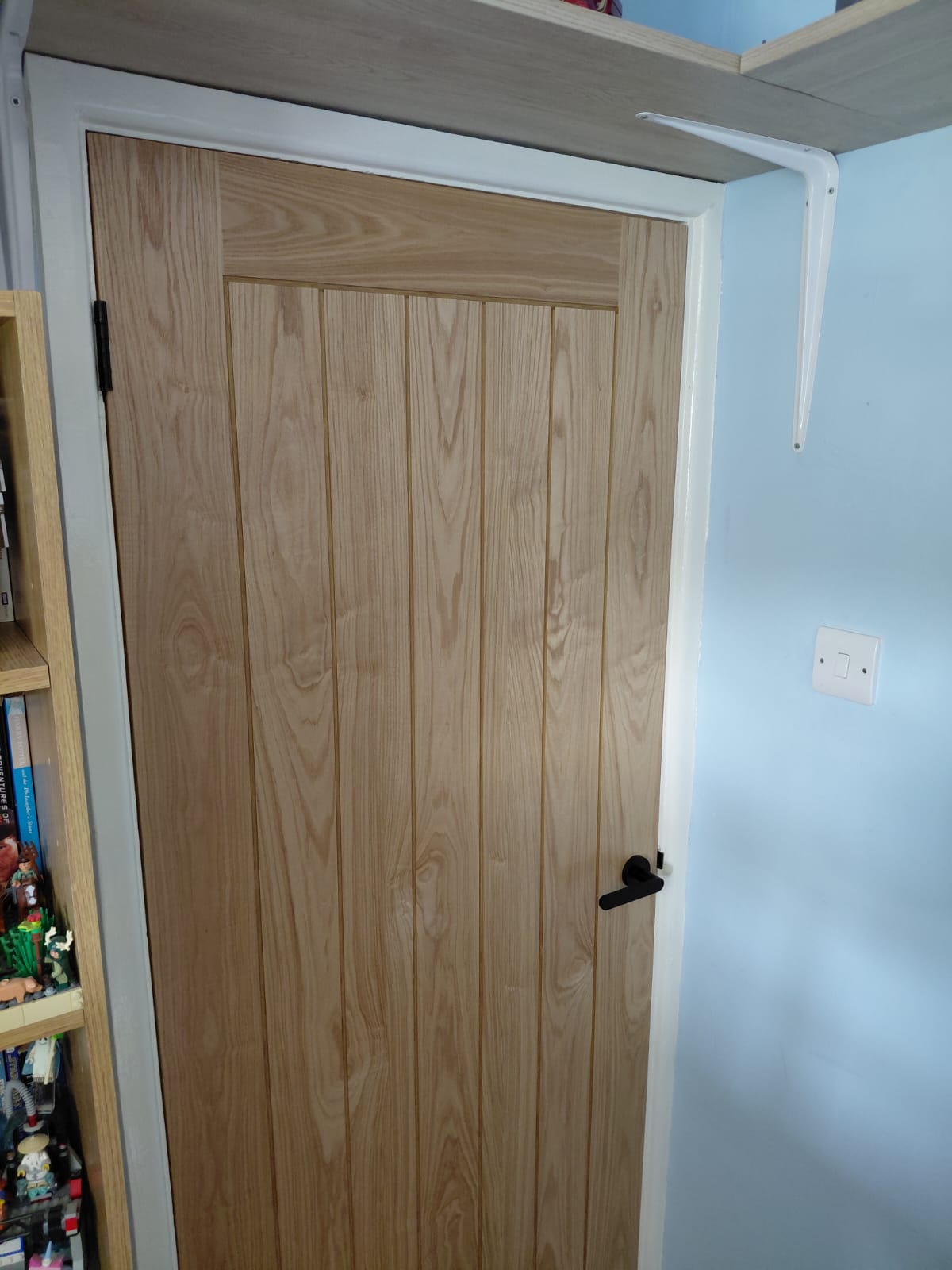 Finished oak door with black ironmongery