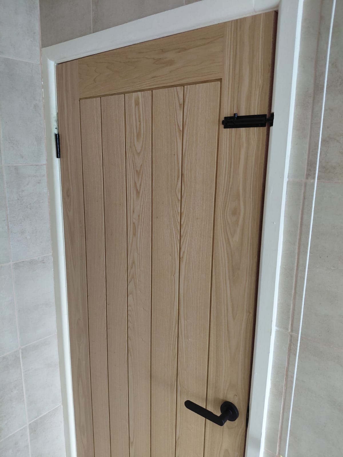 Oak door with black door furniture fitted