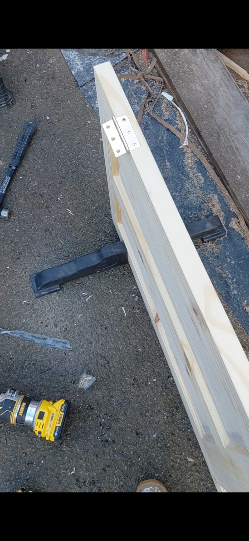 Detail of pine door panels and black ironmongery